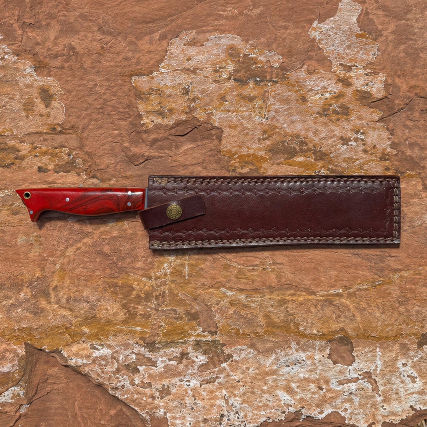 red handle 1095 high carbon steel outdoor chopper knife with long straight blade displayed on rugged stone background for camping and bushcraft use