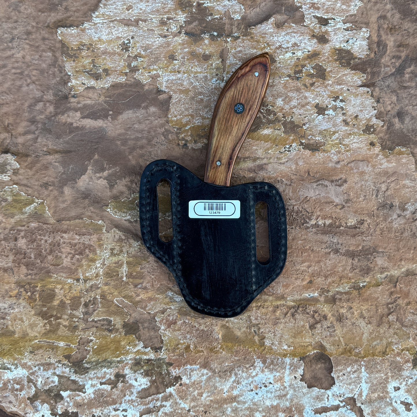 Ridgeback Skinner knife with exotic wood handle
Curved high-carbon steel blade on leather sheath
Close-up of exotic wood handle grain and contour
Ridgeback Skinner displayed on natural wood background
Knife and hand-stitched sheath arranged for product photo
Precision skinner knife in natural lighting
Blue Spade Forge Ridgeback Skinner held in hand for scale
Hunting skinner blade ready for field dressing tasks