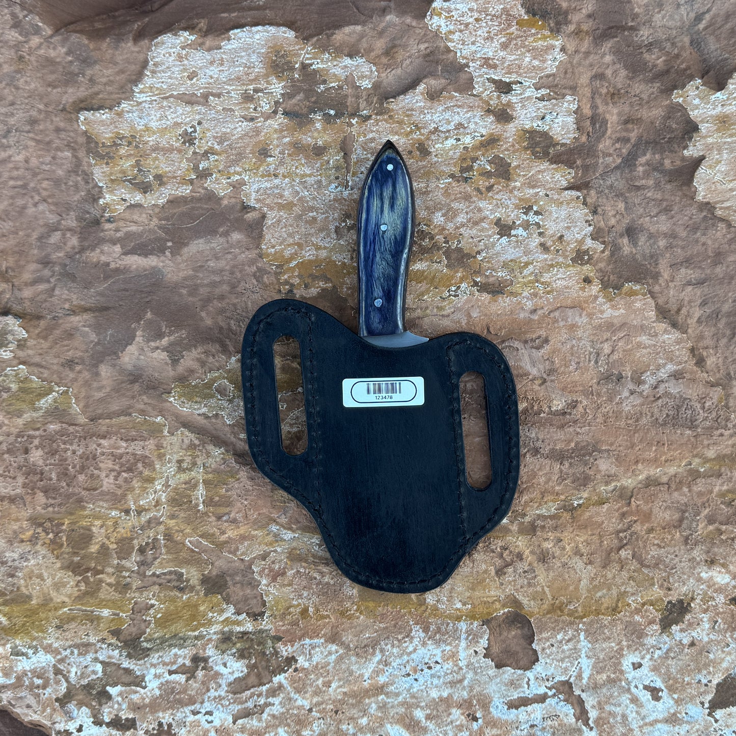 A sleek fixed-blade hunting knife with a curved 1095 high-carbon steel blade and a dark-dyed hardwood handle reinforced with triple pins, shown alongside its hand-stitched leather sheath. Crafted by Blue Spade Forge for hunting, skinning, and rugged outdoor field use.