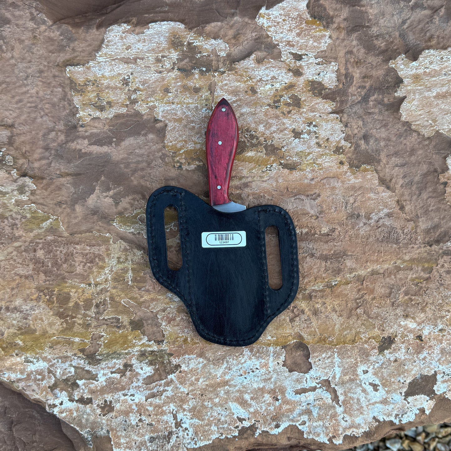 Scarlet Chop cowboy-style knife with squared 1095 blade
Close-up of red dyed hardwood handle
Compact cowboy knife shown with leather sheath
Blade detail showing squared chopping profile
Knife on rustic wood background
Scarlet Chop displayed with hand-stitched brown sheath
Blue Spade Forge Scarlet Chop held in hand for scale
Detail shot of blade edge and red handle grain