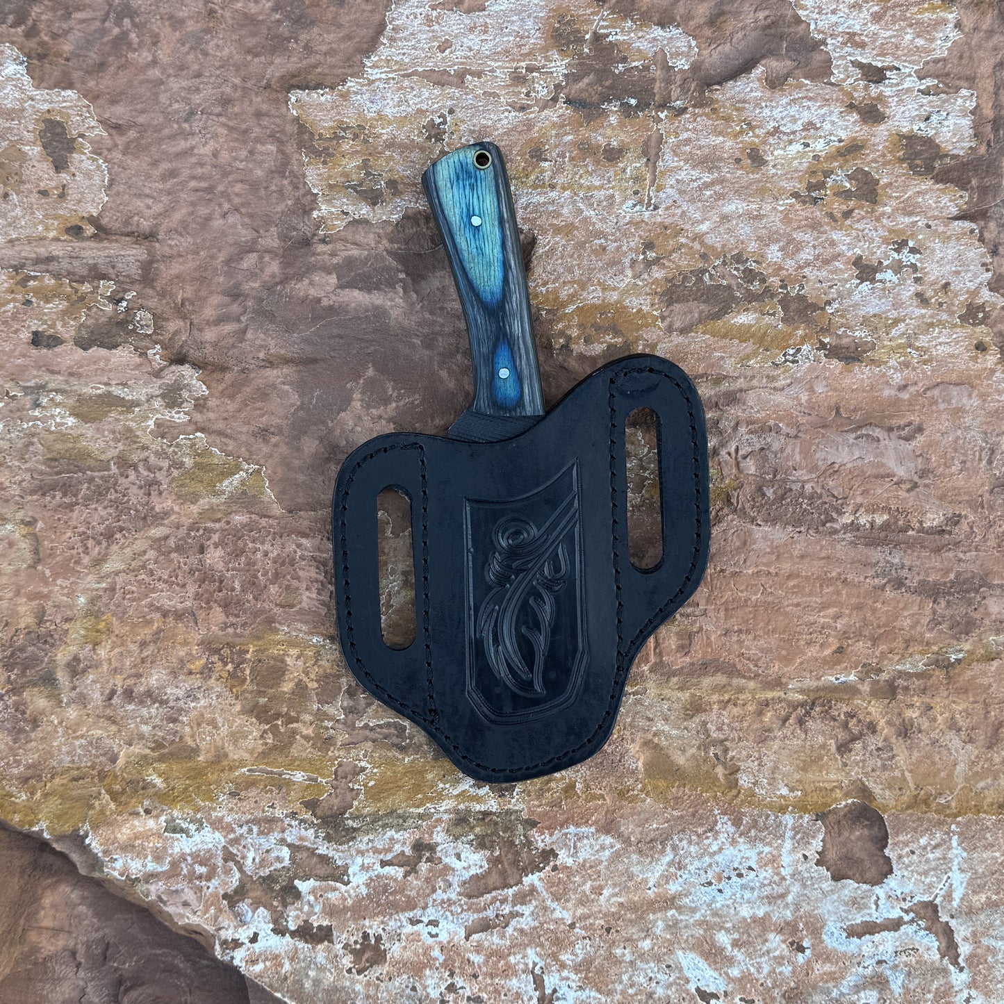 Blue Timber Rasp Knife with rasp-textured blade

Full-tang rasp knife on brown leather sheath

Blue and gray wood-grain handle close-up

Heavy-duty fixed blade displayed on wood background

Knife and hand-stitched leather sheath arranged together

Blue Timber Rasp Knife held in hand for scale

Outdoor utility knife in natural lighting

Rasp-style blade and wood handle detail shot