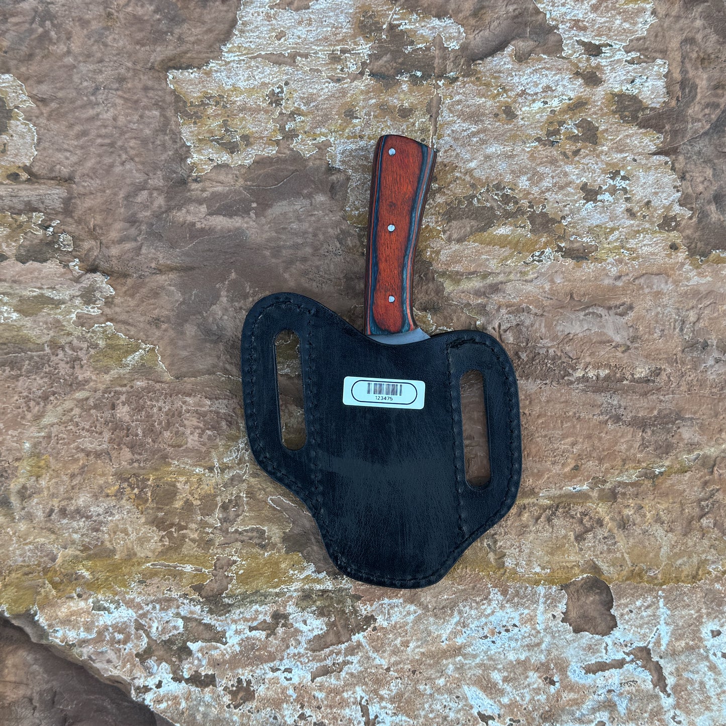 A full-tang drop-point field knife with a satin-finished blade and a richly grained hardwood handle, shown beside a hand-stitched leather sheath. Crafted by Blue Spade Forge for hunting, camping, carving, and rugged outdoor field use.