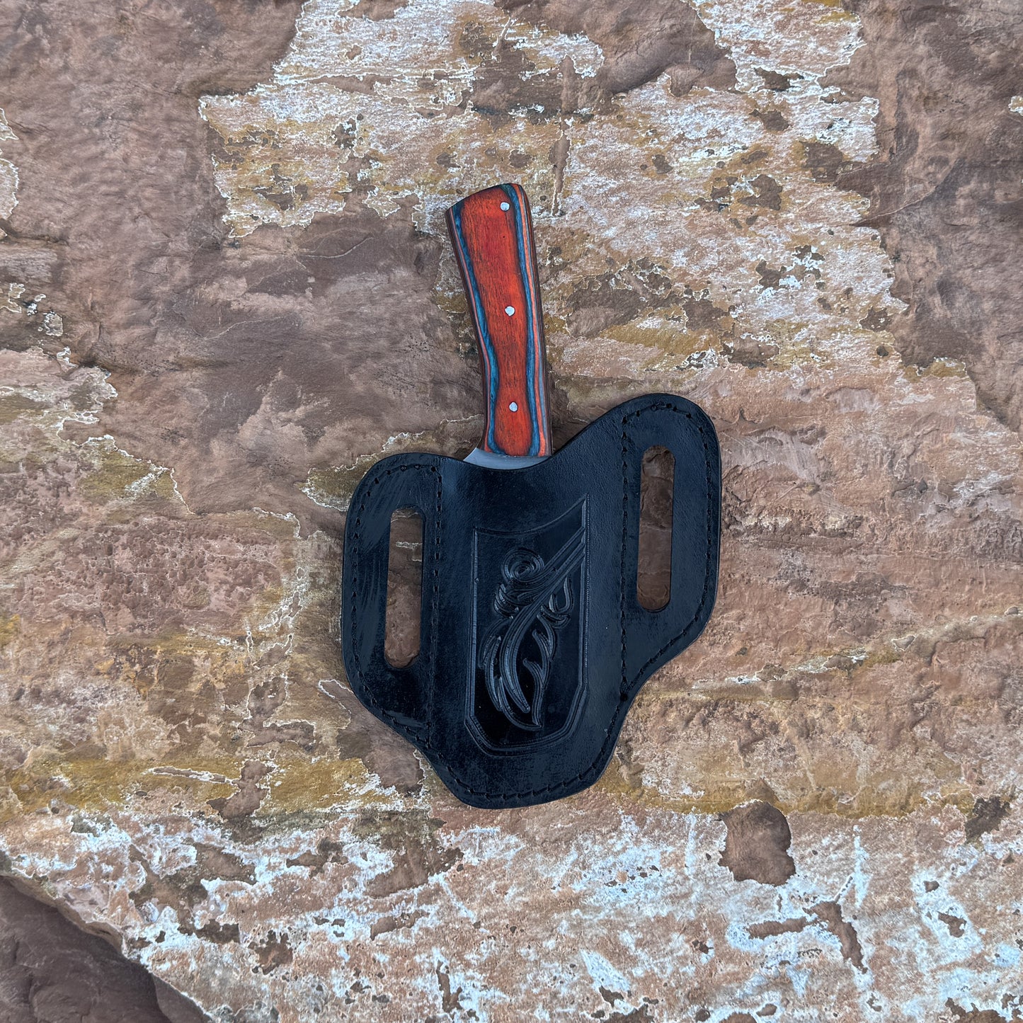 A full-tang drop-point field knife with a satin-finished blade and a richly grained hardwood handle, shown beside a hand-stitched leather sheath. Crafted by Blue Spade Forge for hunting, camping, carving, and rugged outdoor field use.