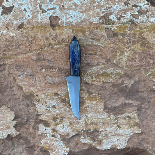 Midnight Ridge stainless fixed blade knife with blue resin handle

Curved stainless blade displayed on hand-stitched leather sheath

Swirled blue resin handle close-up

Midnight Ridge knife on natural wood background

Knife and leather sheath arranged for product display

Outdoor field knife in natural lighting

Blue Spade Forge Midnight Ridge held in hand for scale

Stainless fixed blade ready for trail and outdoor use