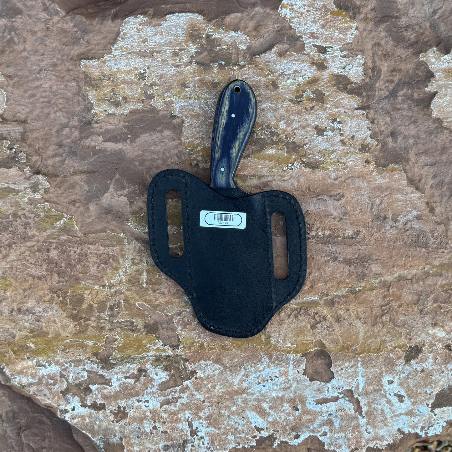 Shadow Rasp Hunter knife with rasp-textured blade

Curved high-carbon steel blade on leather sheath

Dark hardwood handle with rivets close-up

Shadow Rasp Hunter displayed on natural wood background

Knife and hand-stitched sheath arranged for product showcase

Outdoor fixed blade knife in natural lighting

Blue Spade Forge Shadow Rasp Hunter held in hand for scale

Rasp-spine blade and hardwood handle detail shot