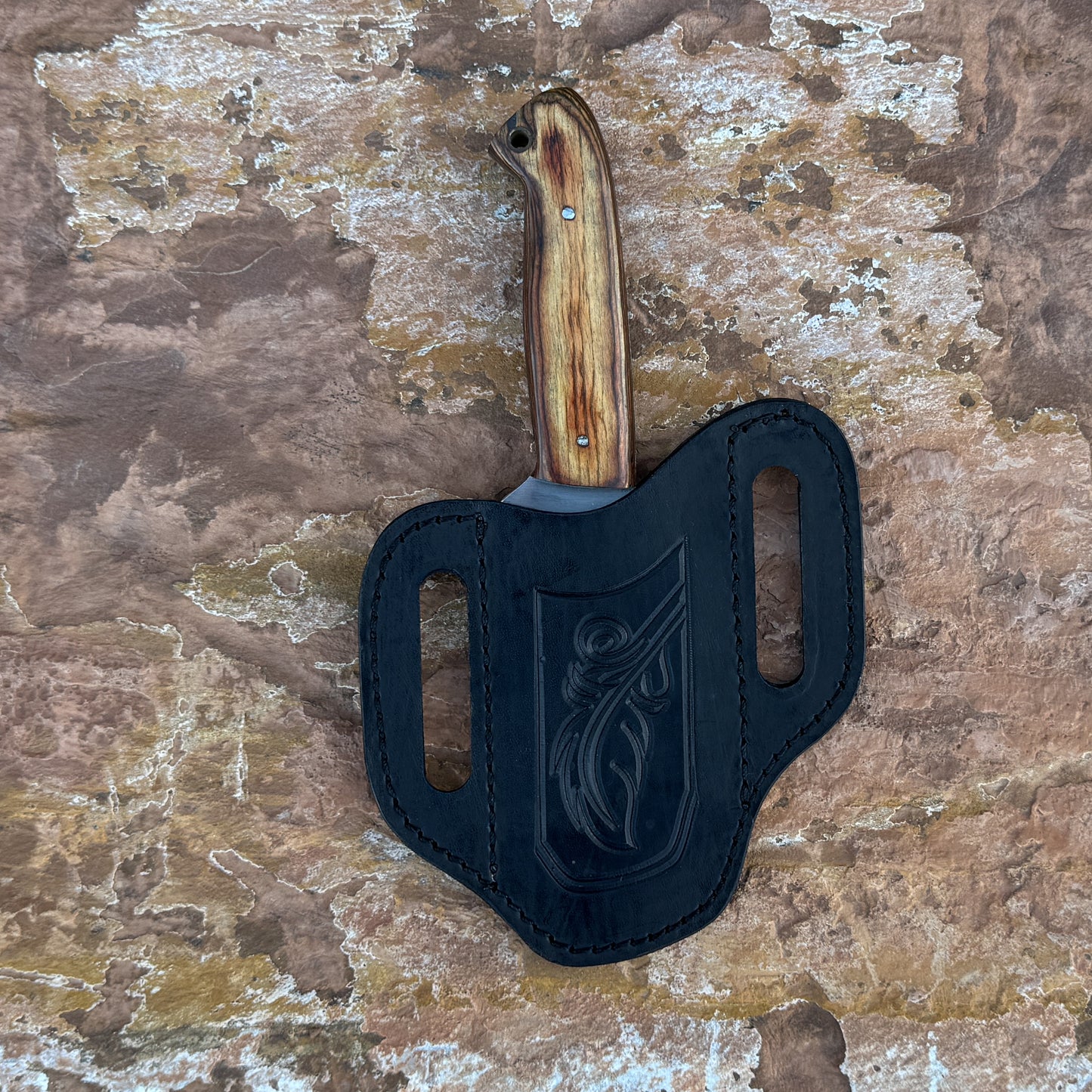 Sandridge stainless fixed blade knife with wood handle

Outdoor knife displayed on brown leather sheath

Natural wood handle with rich grain detail close-up

Stainless blade on rustic wood background

Sandridge knife and hand-stitched sheath arranged together

Fixed blade outdoor knife in natural lighting

Blue Spade Forge Sandridge held in hand for scale

Rugged field knife ready for trail and everyday tasks