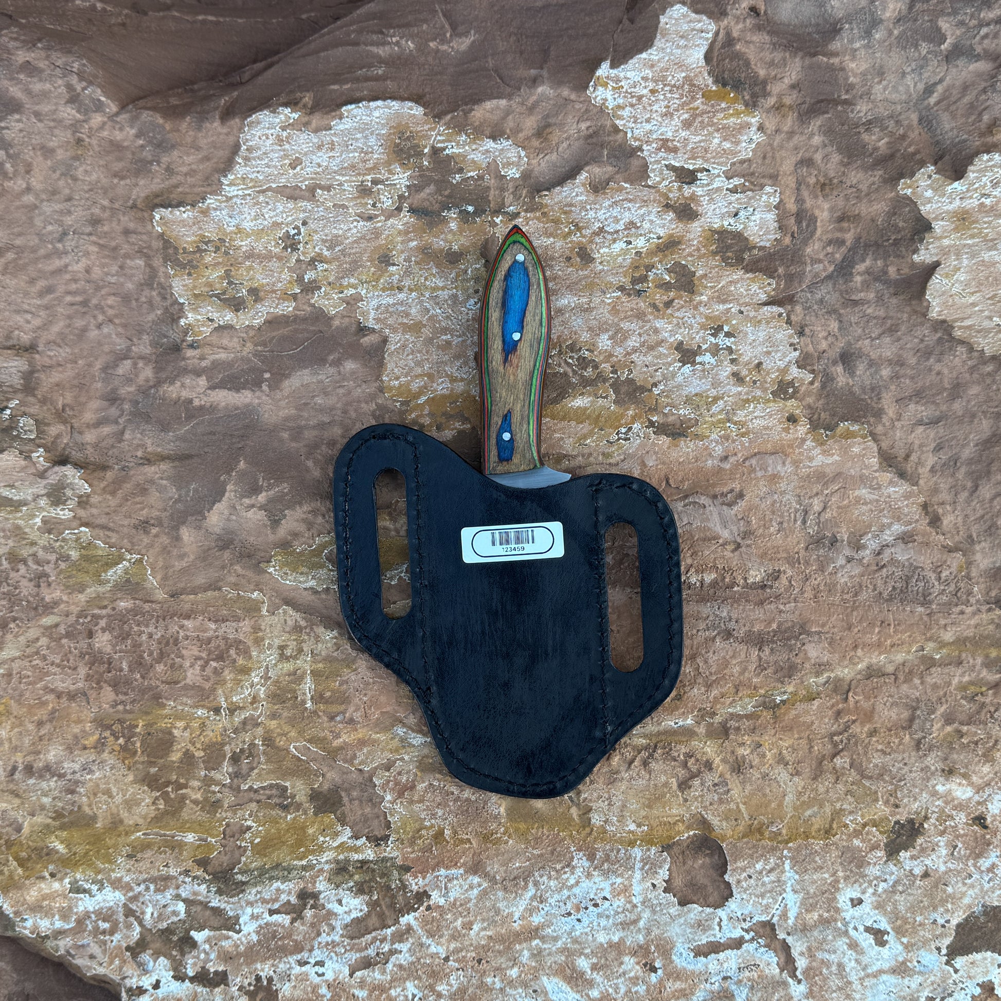 Blue Ridge Skinner knife with multi-tone hardwood handle

Sweeping clip-point blade displayed on leather sheath

Close-up of layered blue, red, green, and natural wood grain

Blue Ridge Skinner on natural wood background

Knife and hand-stitched leather sheath arranged together

Outdoor skinner knife in natural lighting

Blue Spade Forge Blue Ridge Skinner held in hand for scale

Detailed shot of clip-point blade and triple-riveted handle