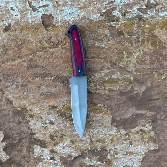 Woodsman Trail full-tang drop point knife on leather sheath

Hand-forged outdoor knife with hardwood handle

Full-tang fixed blade knife for camping and hunting

Blue Spade Forge Woodsman Trail knife in natural lighting

Leather sheath and handcrafted field knife displayed on wood

Close-up of drop-point blade edge on Woodsman Trail knife

Rugged outdoor knife with contoured hardwood grip

Knife and sheath set arranged for product display