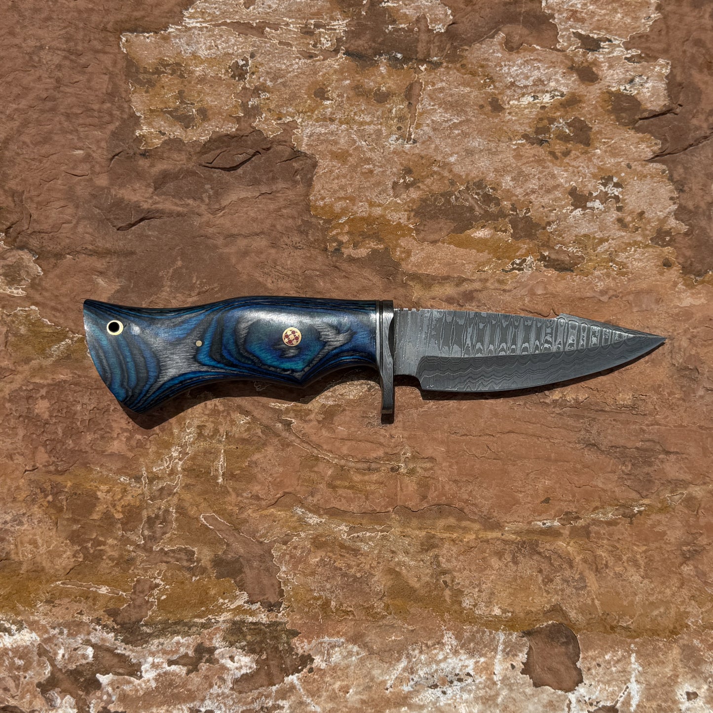 Backwood Hunter Scout hand-forged Damascus hunting knife with contoured blue and black hardwood handle