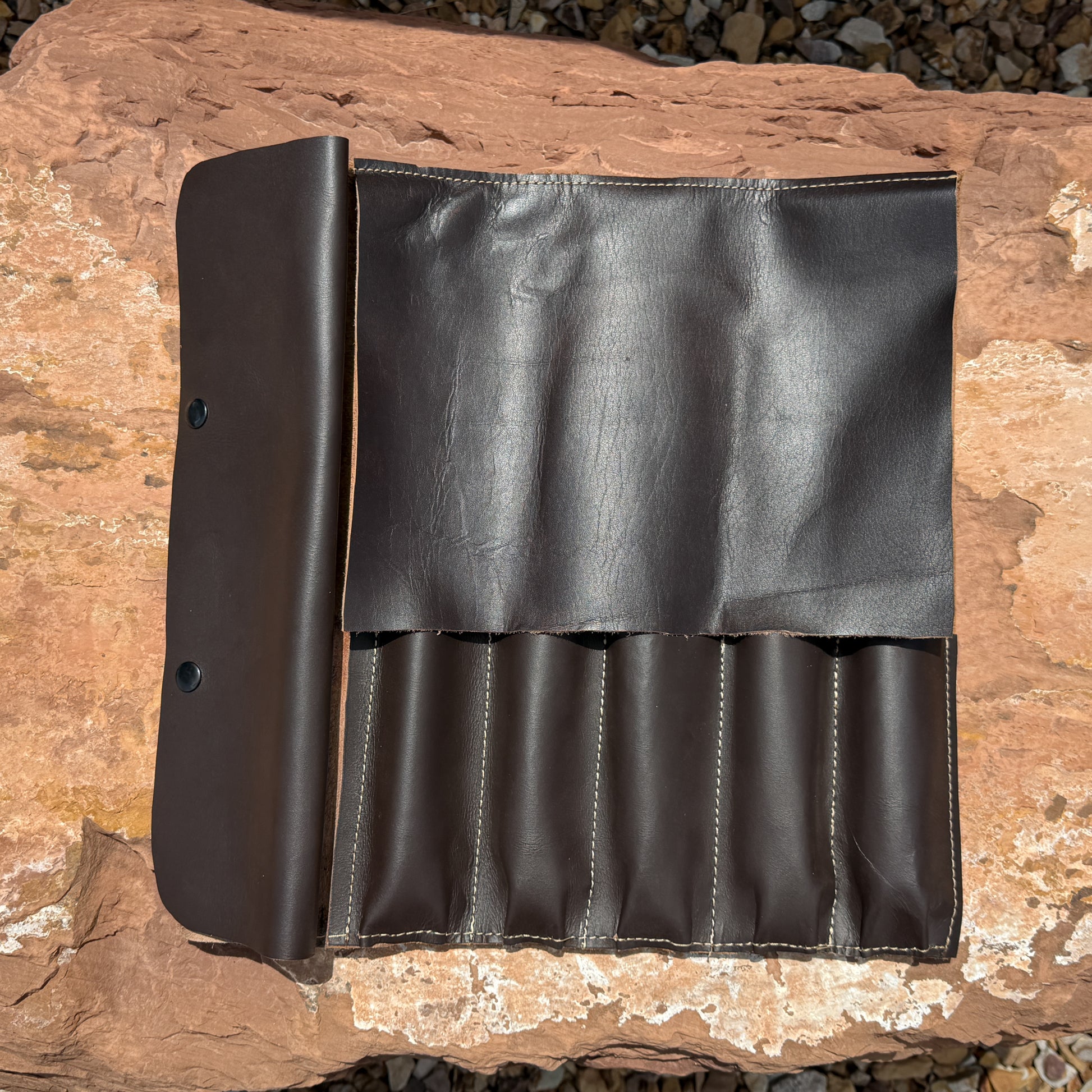Handcrafted leather knife roll holding five Blue Spade Forge high carbon kitchen knives